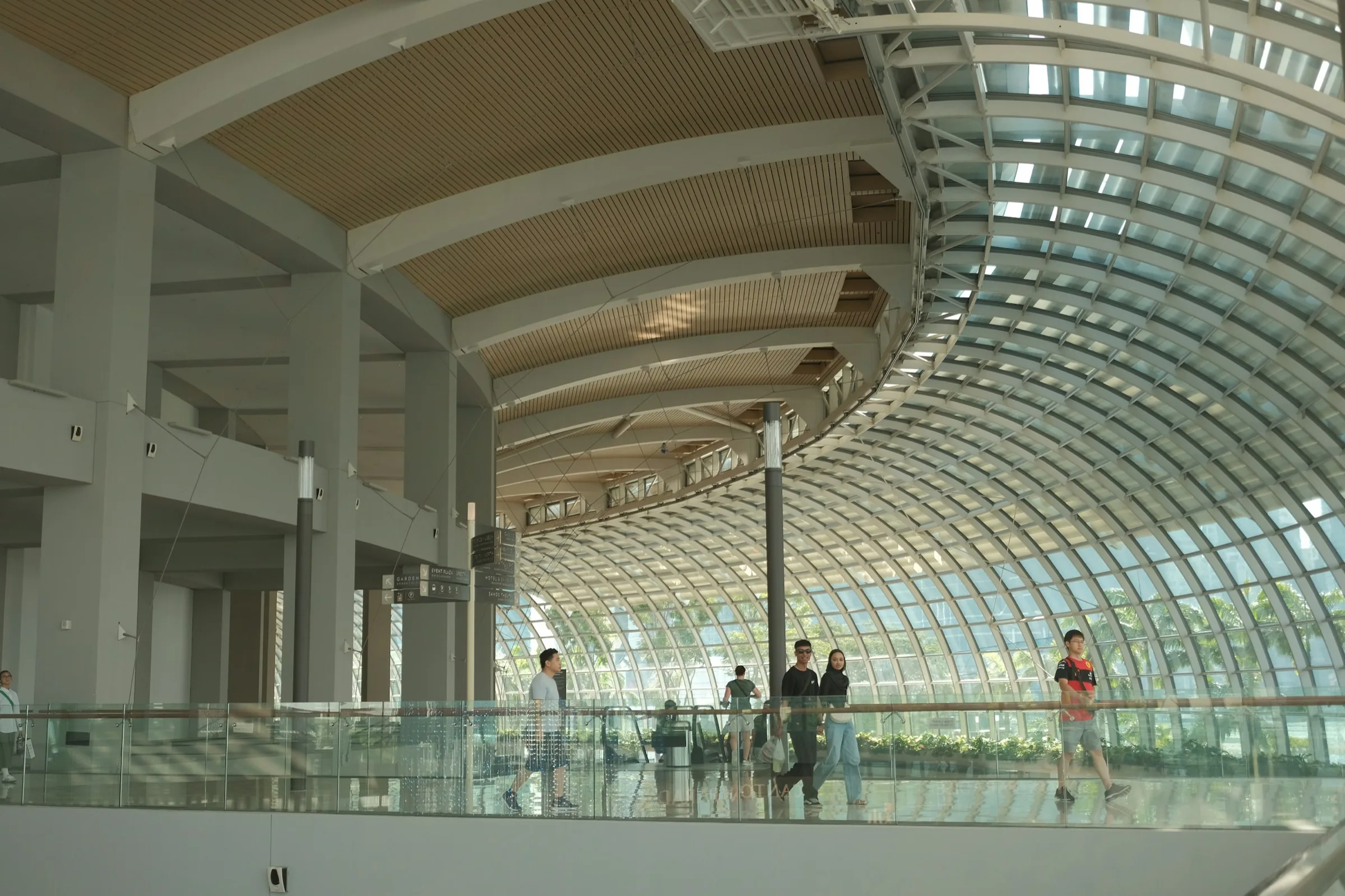 Visitors walking through a vaulted hall