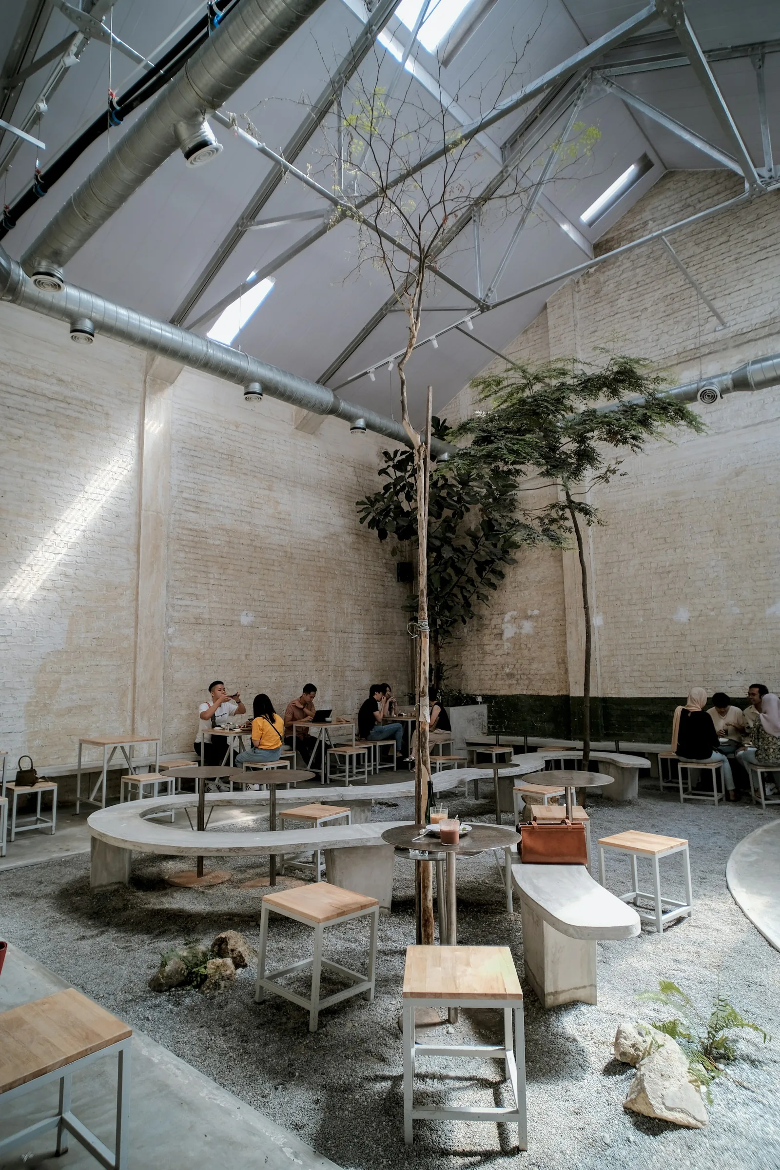 People at tables in a planted commons
