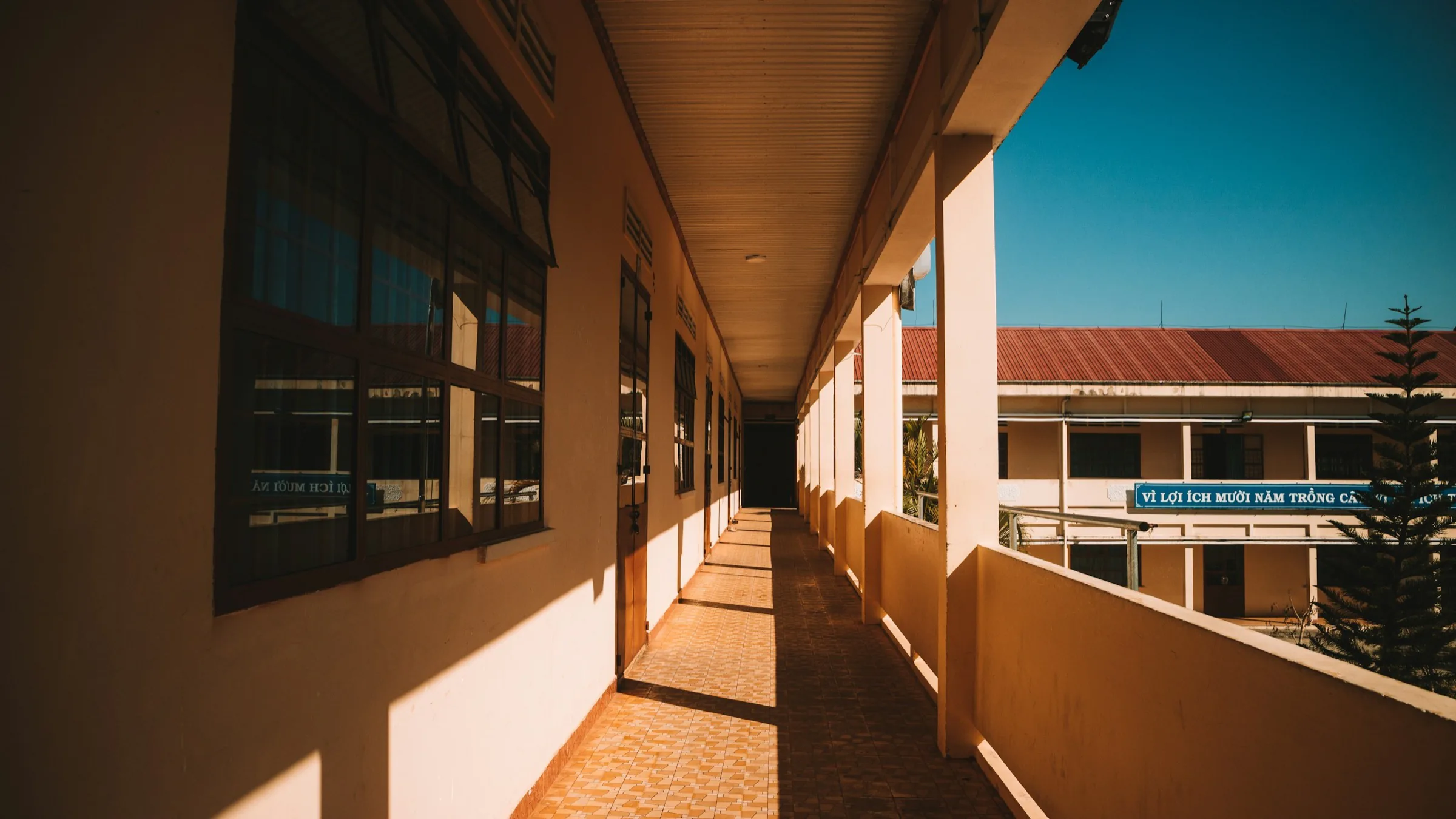 A covered walkway in low sun