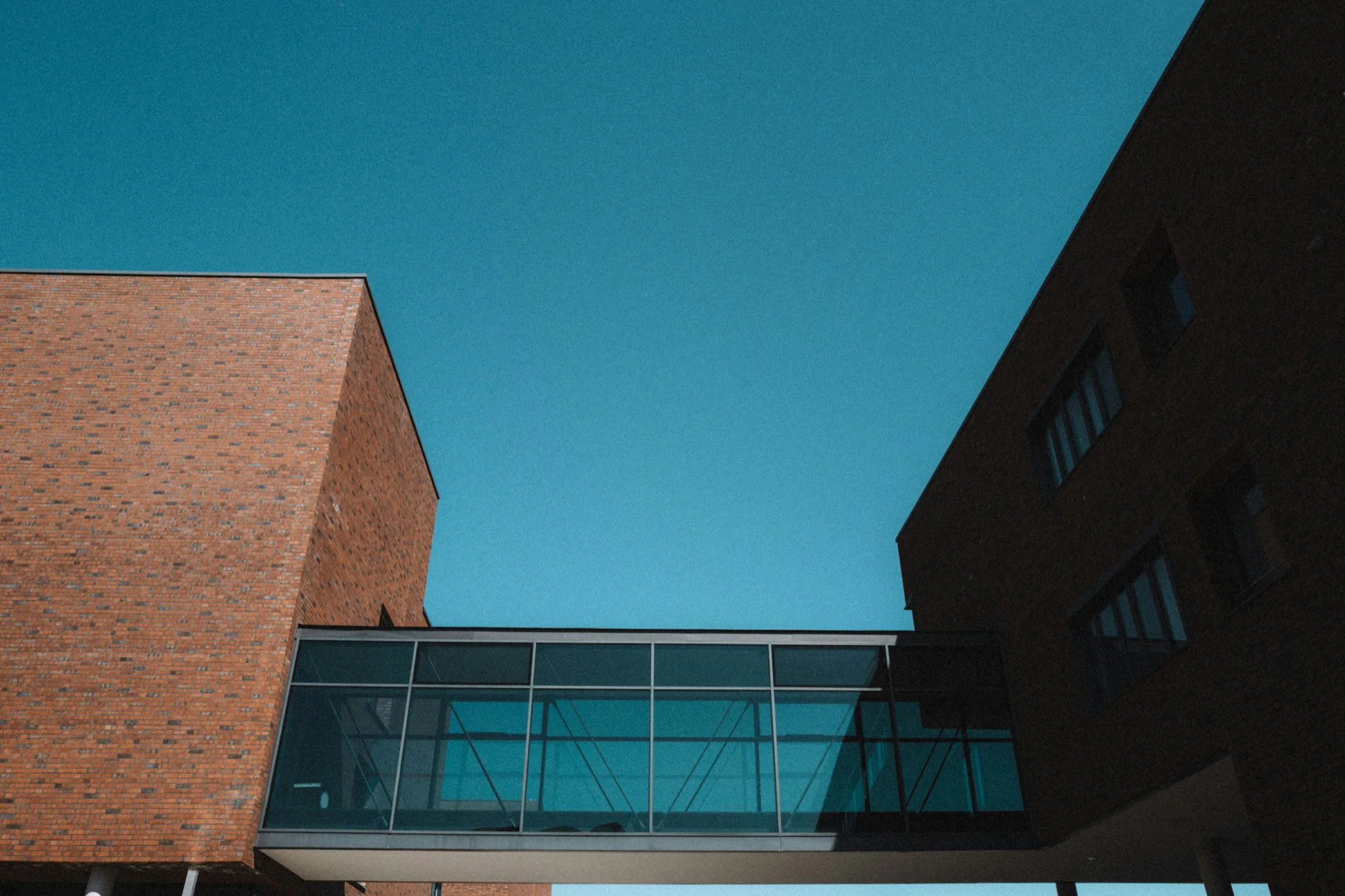 Two brick school buildings joined by a glazed bridge