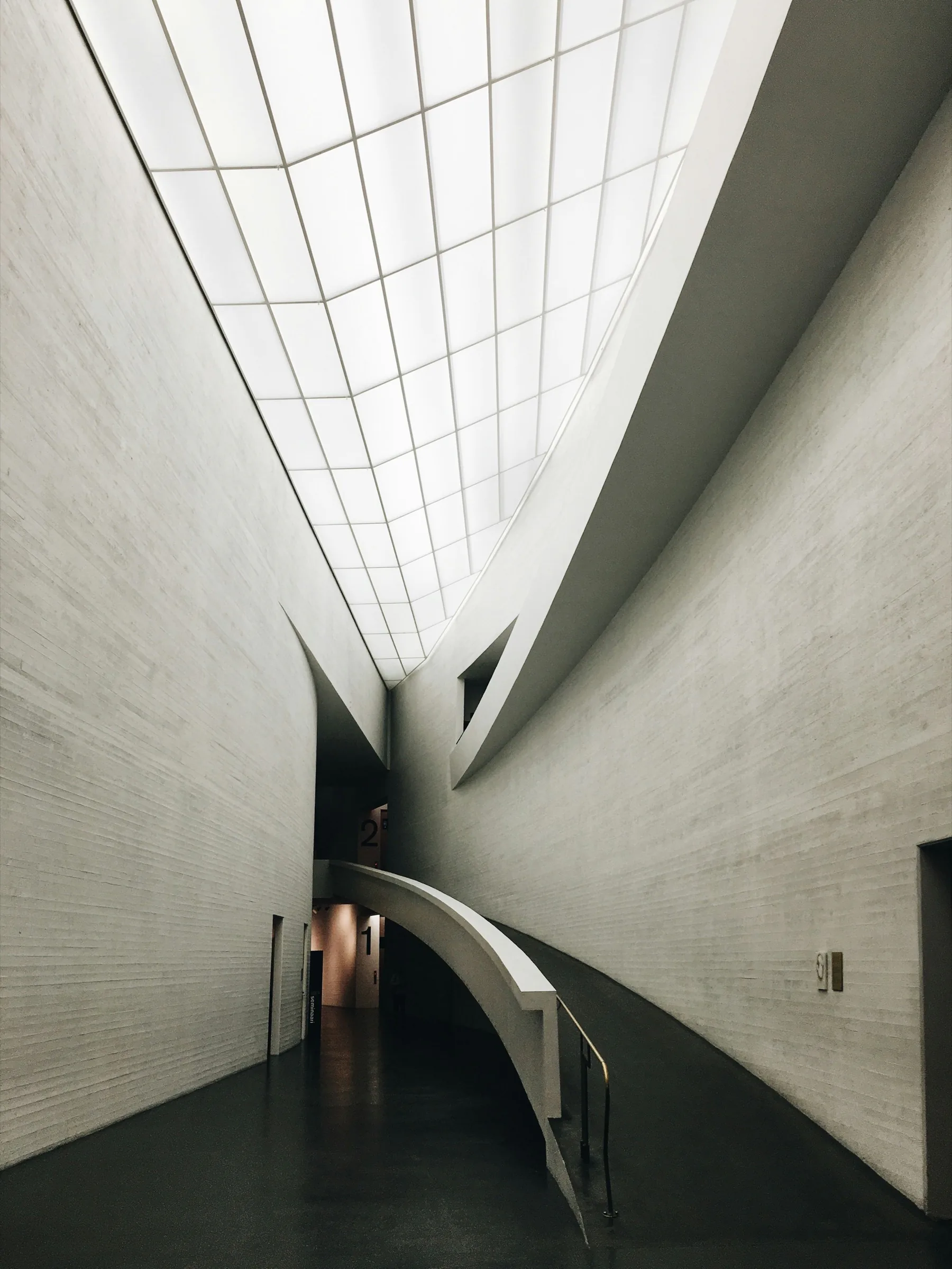 Tall concrete room with a glazed roof slot