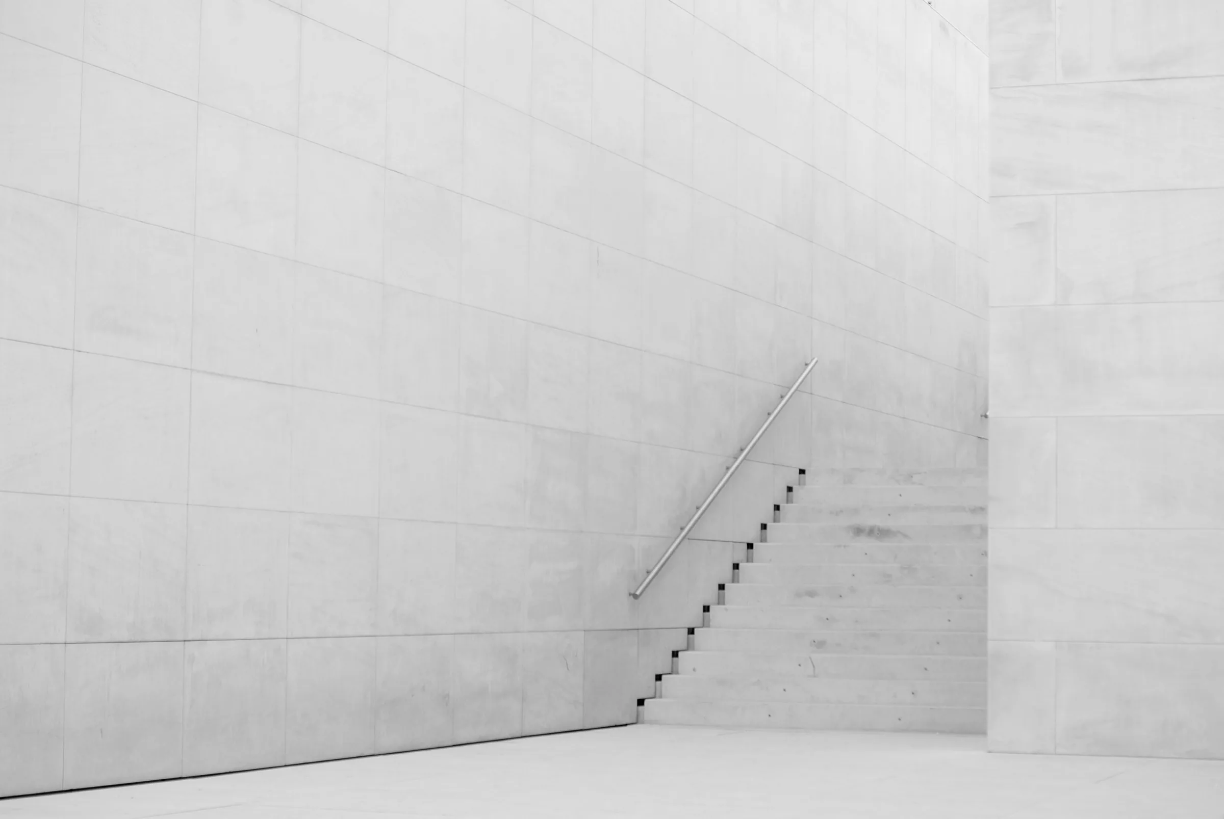 White concrete wall with a thin stair cut into it
